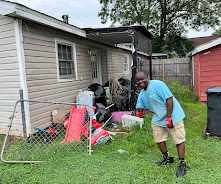 RID-ICK crew working beside a large real junk and property cleanout pile