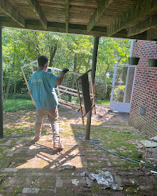 RID-ICK crew member carrying removed material from a property